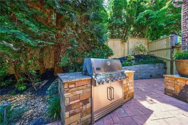 a spacious bathroom with a granite countertop double vanity sink and a mirror