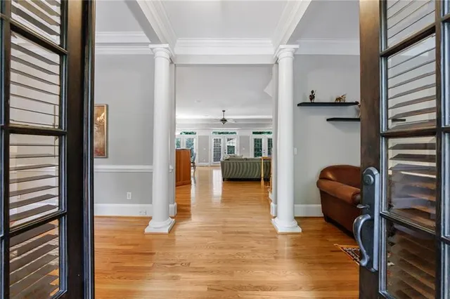 a dining room with furniture a chandelier and wooden floor