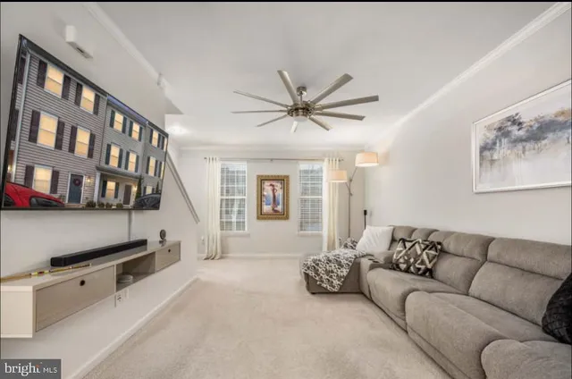 a living room with furniture and a book shelf
