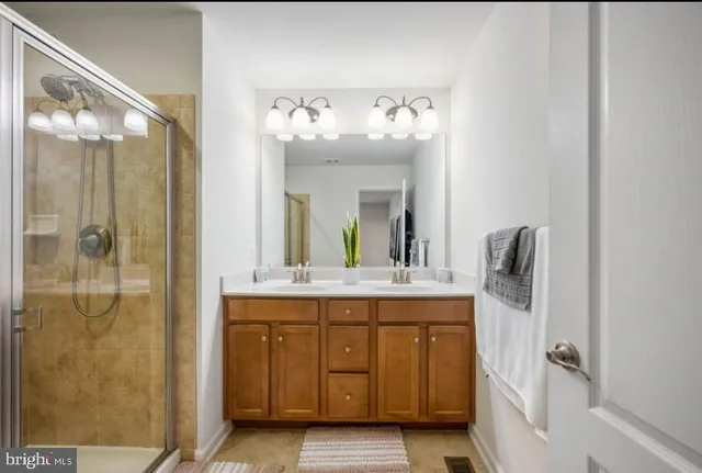 a bathroom with a glass shower door