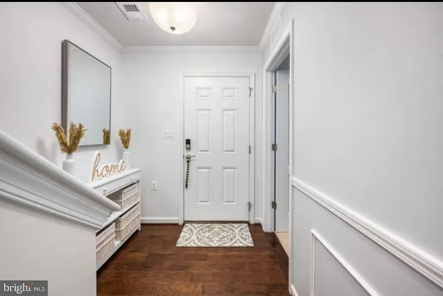 a hallway with white cabinets