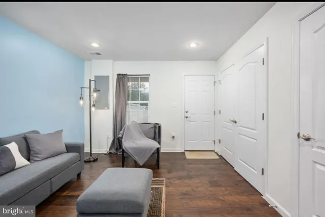 a living room with furniture and a rug