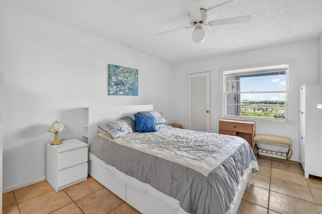 a bedroom with a large bed and a flat screen tv