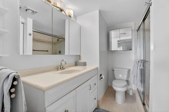 a spacious bathroom with a double vanity sink mirror and toilet