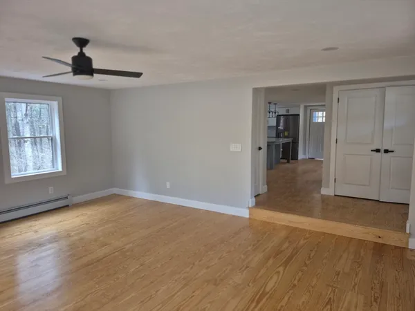 wooden floor in an empty room with a window