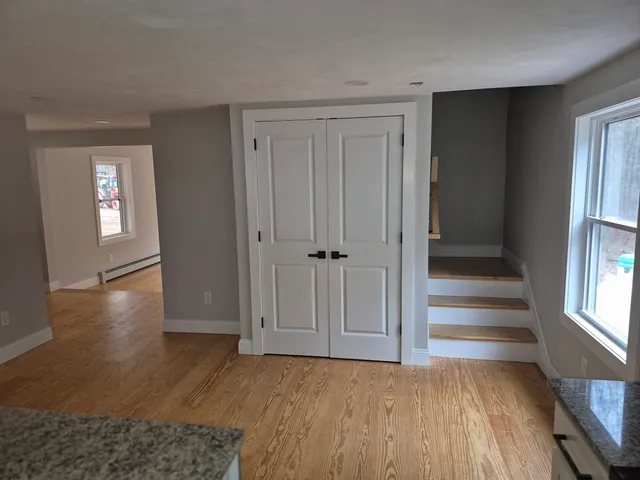 wooden floor in an empty room with a window