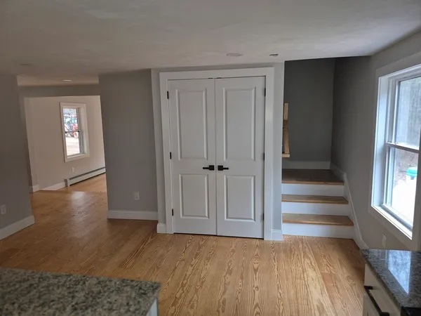 wooden floor in an empty room with a window