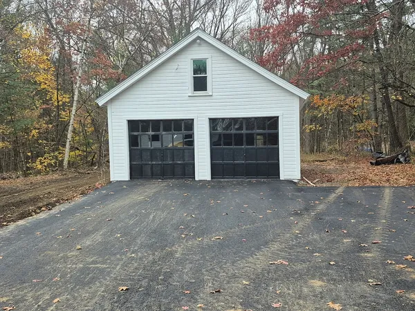 a view of a house with a yard and garage