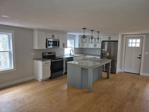 a kitchen with a stove top oven and sink
