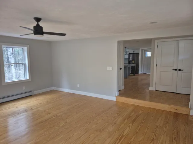 wooden floor in an empty room with a window