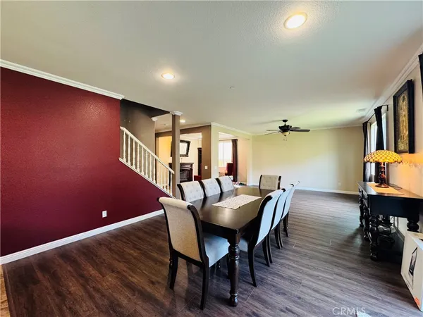 a dining room with furniture and wooden floor