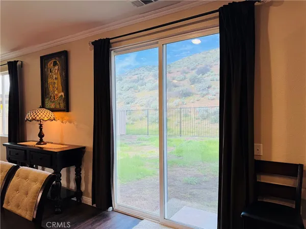 a kitchen with stainless steel appliances granite countertop a refrigerator a stove a sink a dining table and chairs