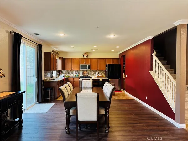 a kitchen with a stove a sink a microwave and wooden cabinets