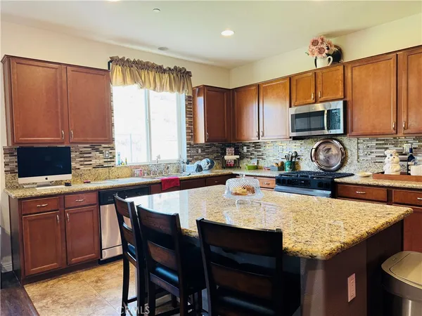 a kitchen with a stove a sink and a microwave