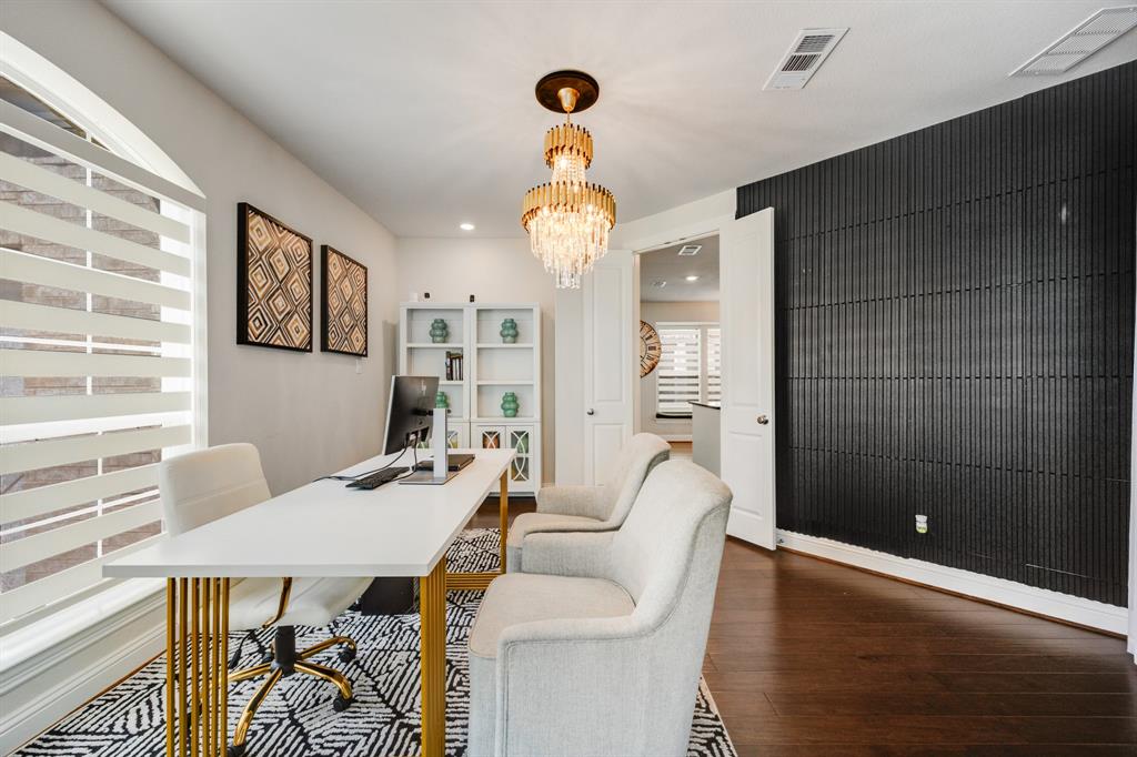 1524 Buckthorn Road Fate, TX 75087 - Photo 15 of 37 a view of a dining room with furniture a chandelier and wooden floor