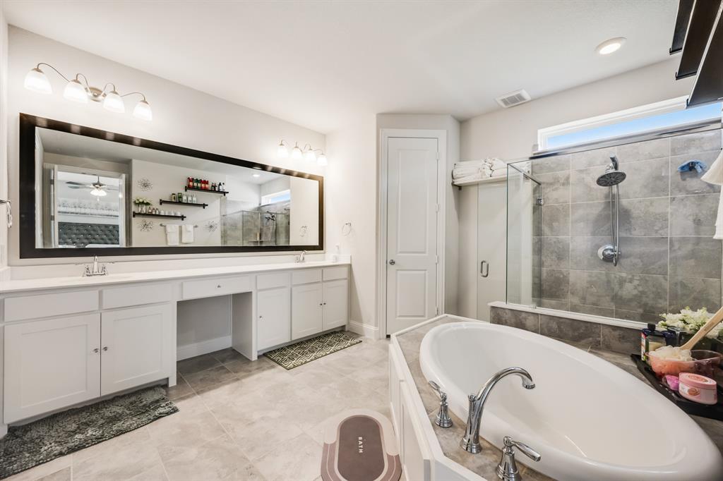 1524 Buckthorn Road Fate, TX 75087 - Photo 27 of 37 a bathroom with a double vanity sink mirror and bathtub