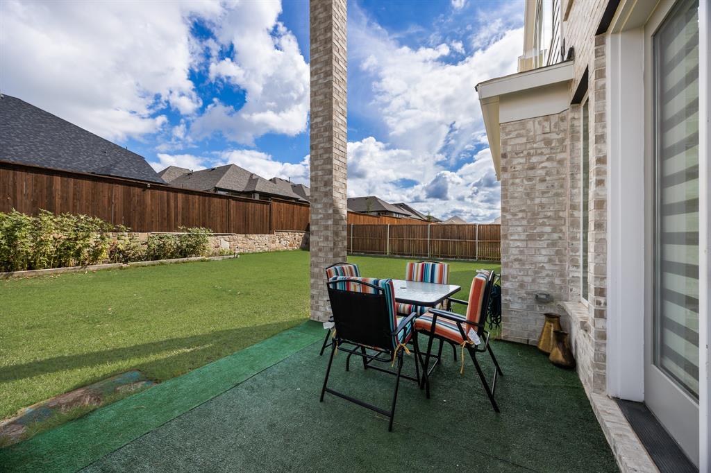 1524 Buckthorn Road Fate, TX 75087 - Photo 33 of 37 a backyard of a house with table and chairs