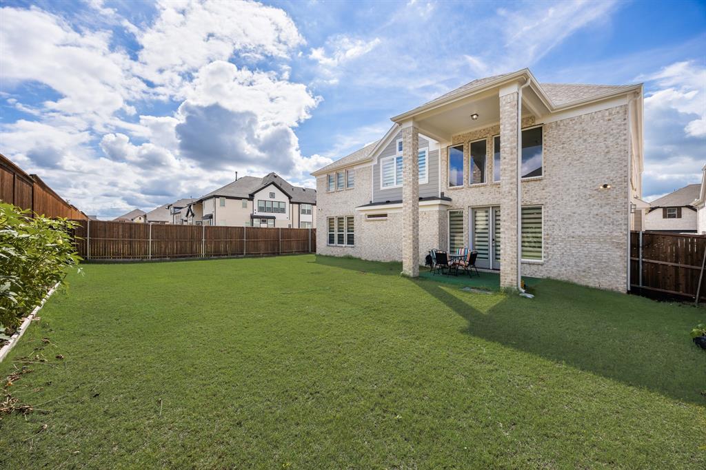 1524 Buckthorn Road Fate, TX 75087 - Photo 34 of 37 a view of a house next to a big yard with plants and a large tree