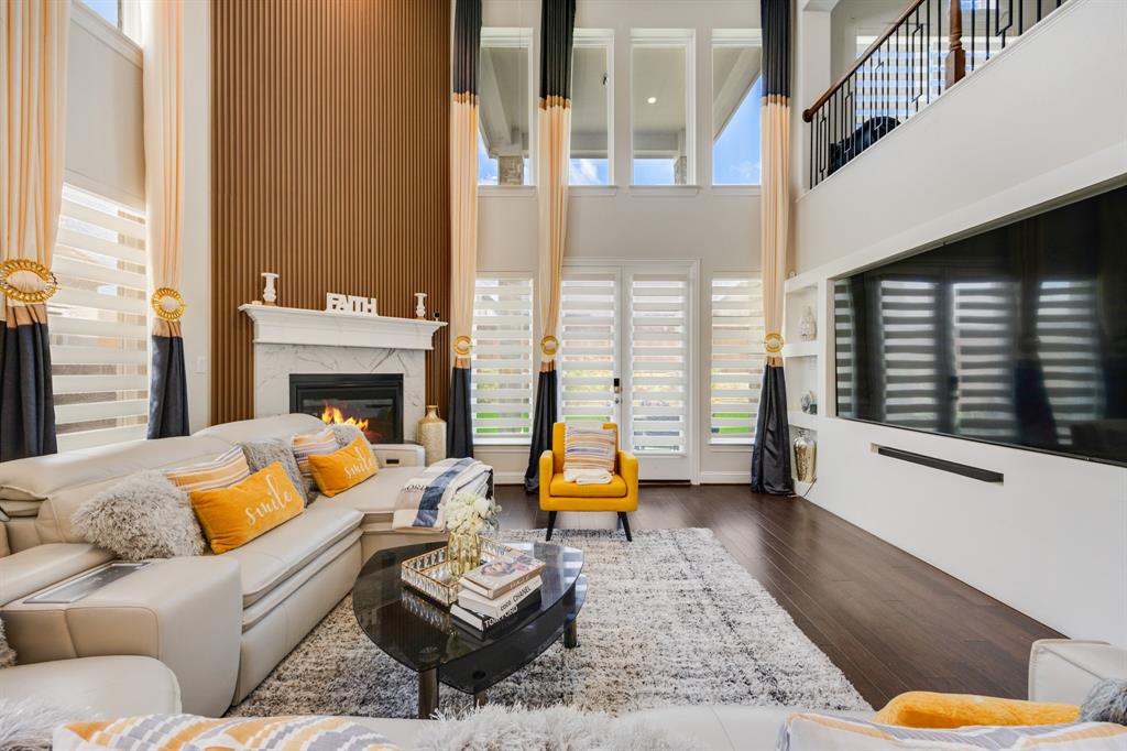 1524 Buckthorn Road Fate, TX 75087 - Photo 10 of 37 a living room with furniture and a fireplace