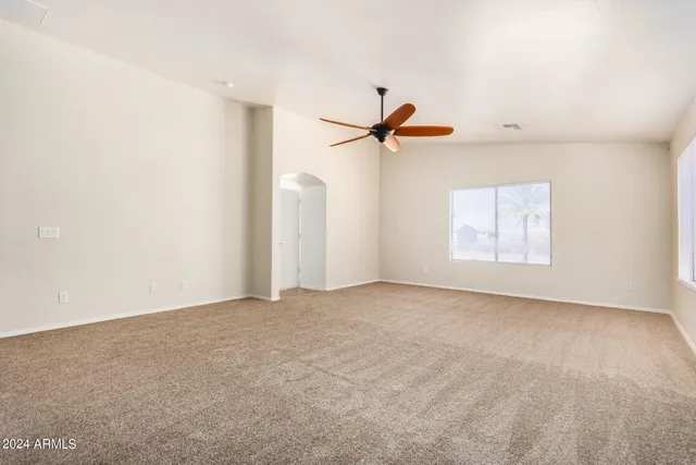a view of a room with a projector and ceiling fan