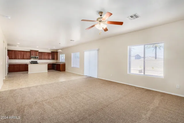 a view of a livingroom with furniture and kitchen view