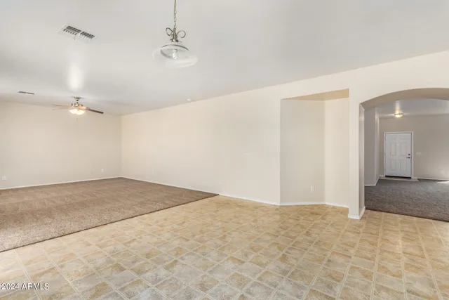 a kitchen with stainless steel appliances granite countertop a stove top oven a sink and a refrigerator