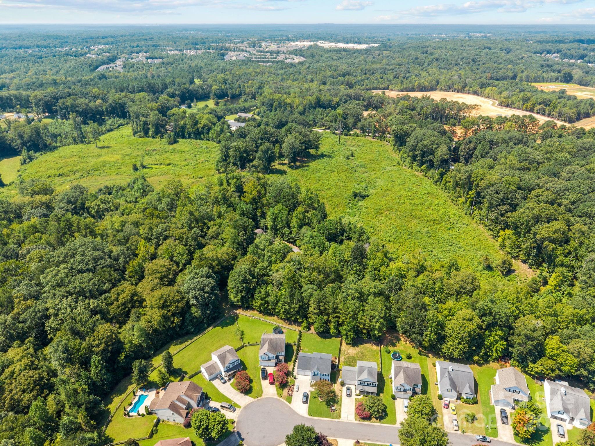 8194 Henry Harris Road, Unit 5 Fort Mill, SC 29707 - Photo 5 of 25 an aerial view of residential houses with outdoor space and trees