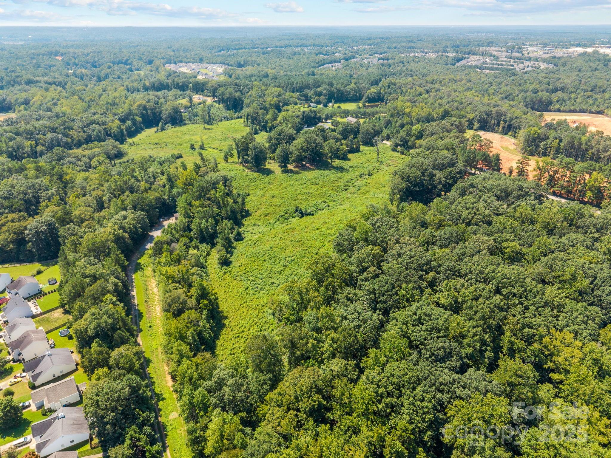 8194 Henry Harris Road, Unit 5 Fort Mill, SC 29707 - Photo 7 of 25 an aerial view of residential house with outdoor space and trees all around
