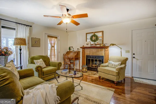 a living room with furniture a fireplace and a flat screen tv