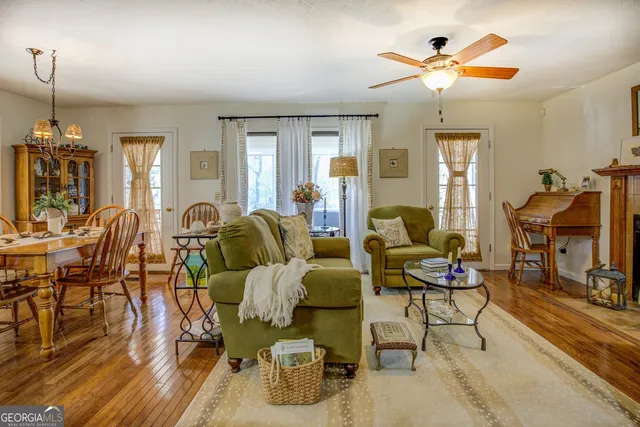 a view of a dining room with furniture a chandelier and wooden floor
