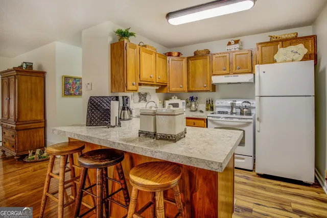 a kitchen with stainless steel appliances granite countertop a sink and a stove