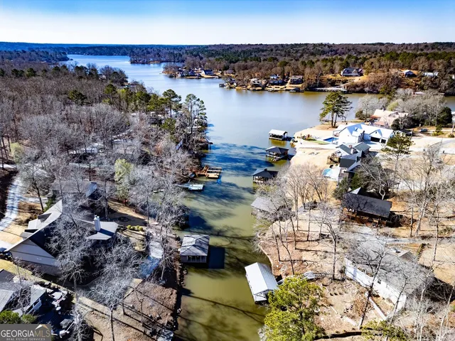 an aerial view of a houses with ocean view