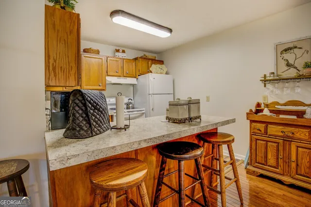 a bathroom with a granite countertop toilet sink and mirror