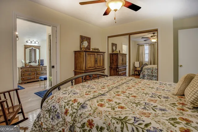 a white bath tub sitting next to a white toilet and a shower