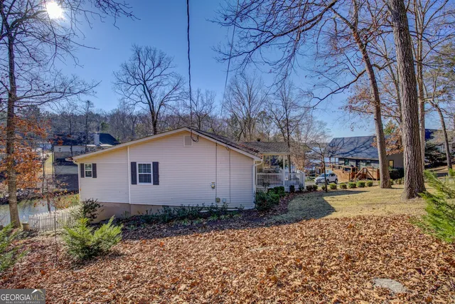a view of a rooftop deck with couch and chairs