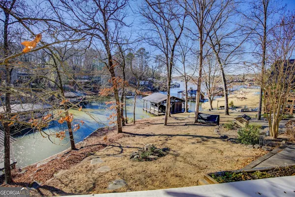 a living room with furniture a fireplace and a chandelier