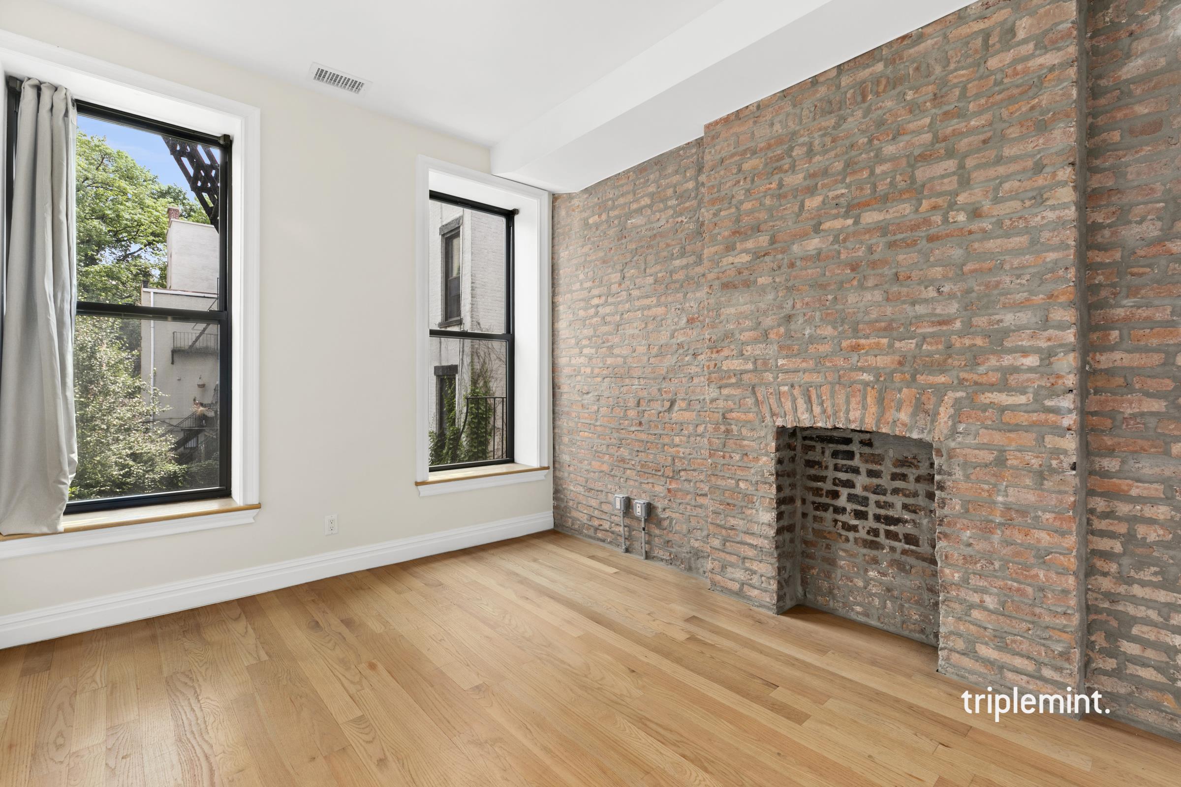 153 7th Avenue, Unit 2 Brooklyn, NY 11215 - Photo 1 of 1 a view of an empty room with wooden floor and a window