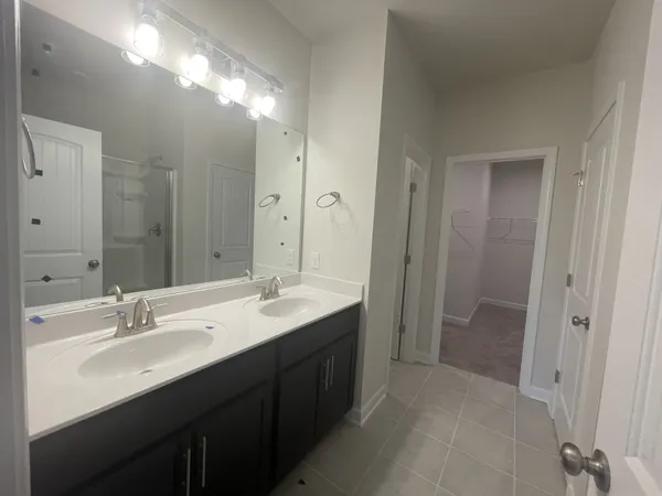 a bathroom with a double vanity sink mirror and double
