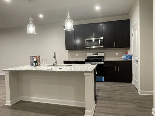 a kitchen with a sink and a stove top oven