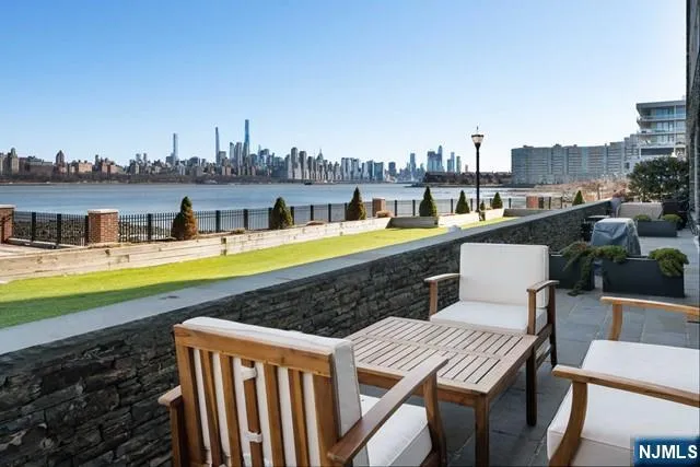 a view of a swimming pool with a chairs and table on the terrace