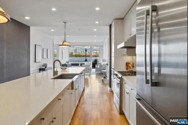 a large kitchen with stainless steel appliances lots of counter top space