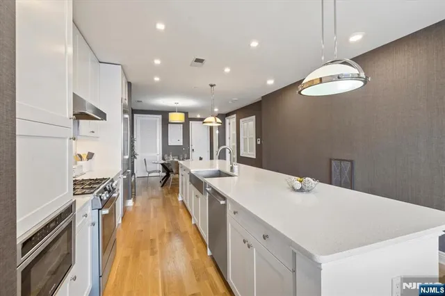 a large kitchen with kitchen island a sink and a large island