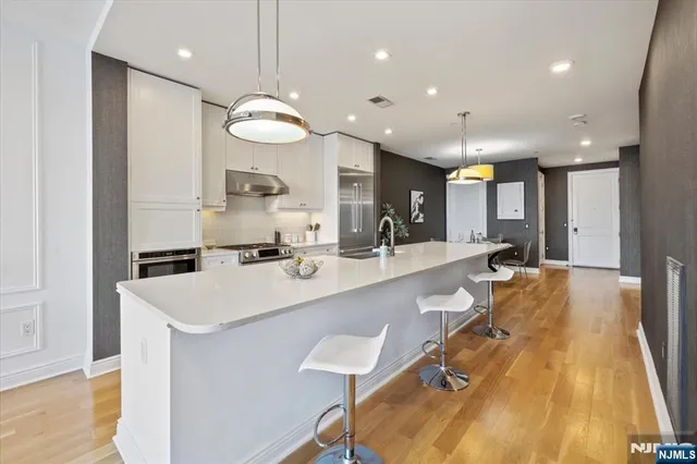 a view of a dining room with furniture and a chandelier