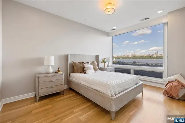 a bedroom with a large bed and a large window