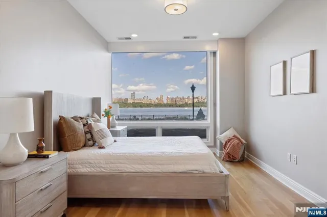 a bedroom with a bed and a potted plant