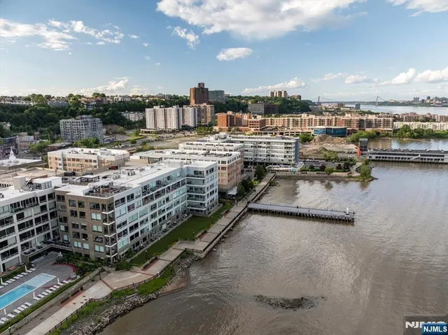 a view of a balcony with a couple of cars parked in parking lot
