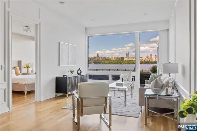 a dining room with furniture a rug and a floor to ceiling window