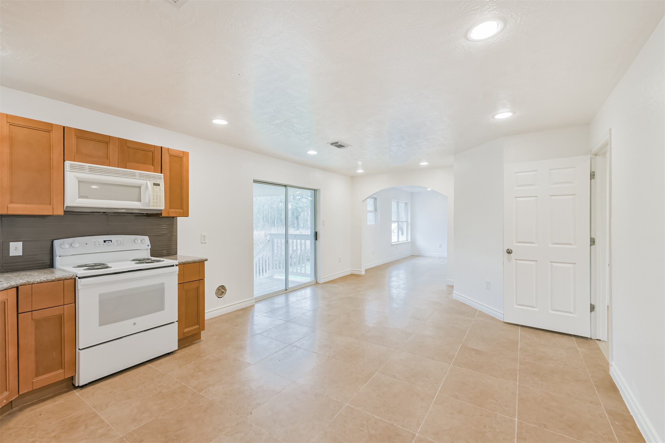 10412 Ehlers Road Conroe, TX 77302 - Photo 12 of 37 a view of a kitchen with stainless steel appliances granite countertop a stove and a refrigerator