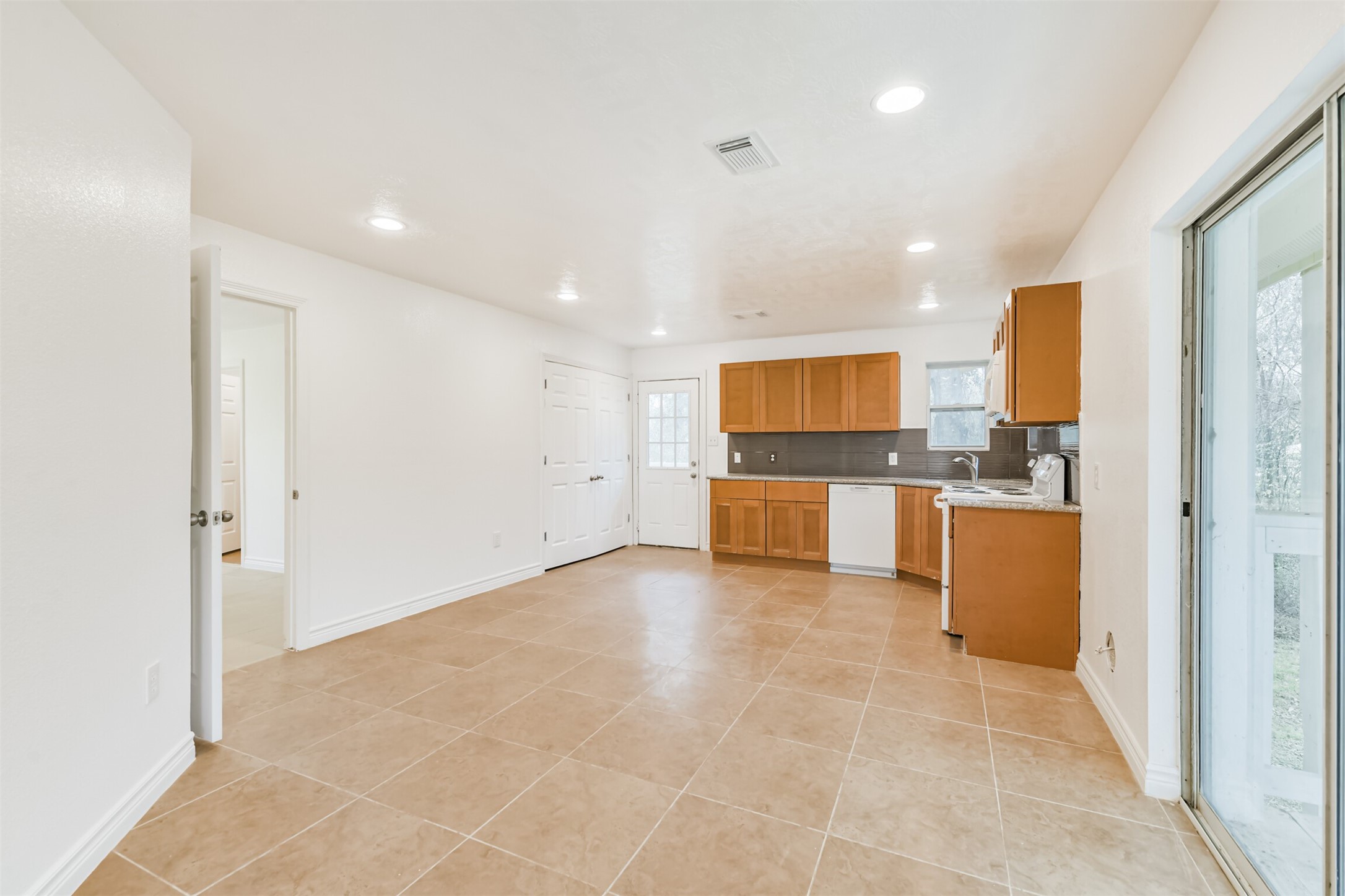 10412 Ehlers Road Conroe, TX 77302 - Photo 13 of 37 a view of a kitchen with a sink and a refrigerator