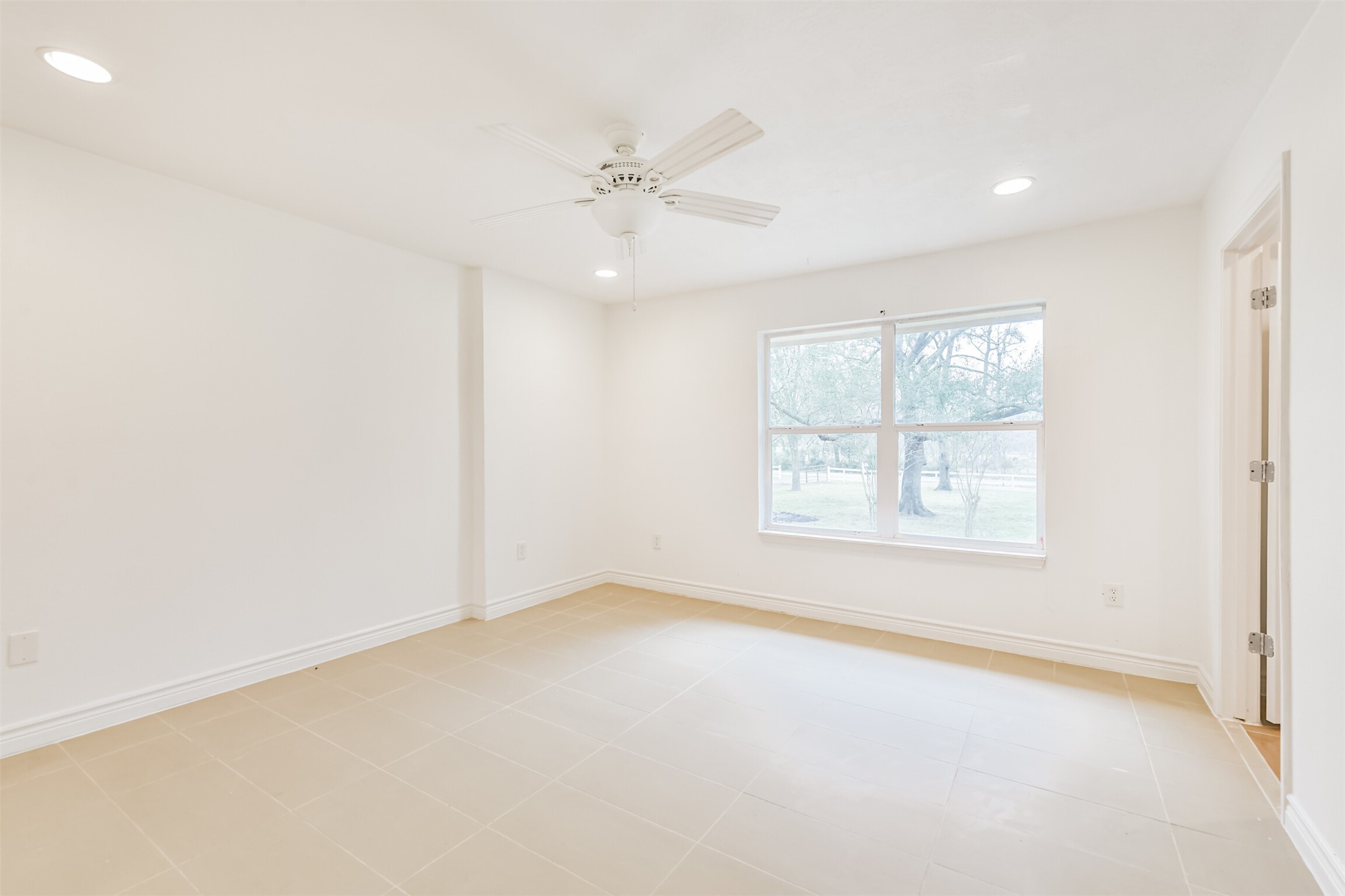 10412 Ehlers Road Conroe, TX 77302 - Photo 19 of 37 an empty room with a window and a fan